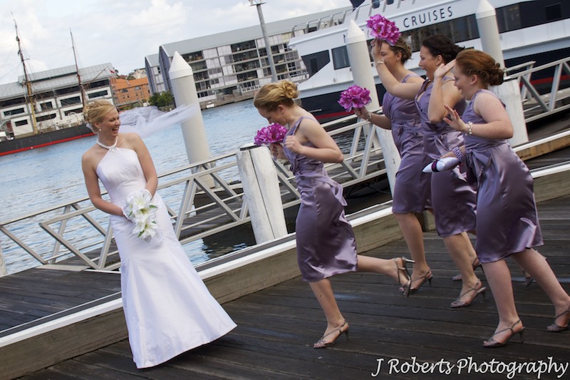 Bridesmaids running to bride laughing - wedding photography